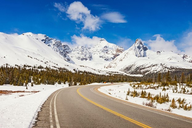 Icefields Parkway and the east face of Mount Athabasca in Alberta, Canada, on a sunny day.