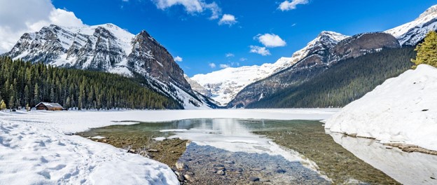 Lake Louise at Banff National Park landscape with ice brake, water, and mountain reflection.