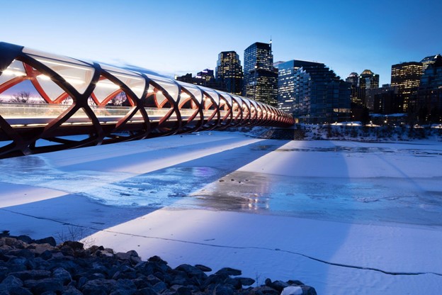 Peace Bridge in Calgary stretching across the Bow River, early morning before sunrise.