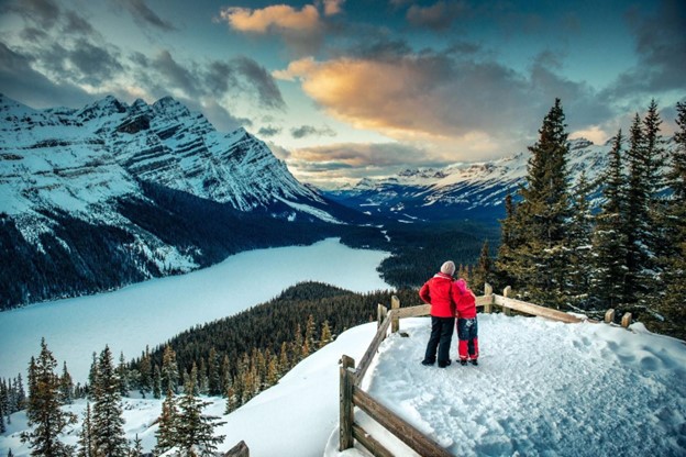 Couple enjoying a winter mountain view at Banff National Park near Calgary
