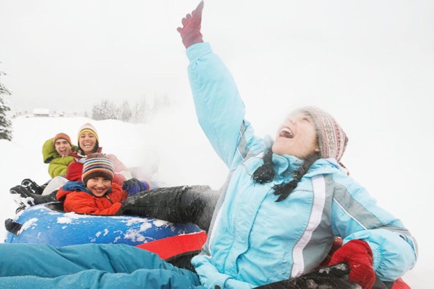 A family tubing at WinSport Tube Park in Calgary