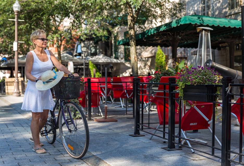 Woman tourist cycling in Quebec city 