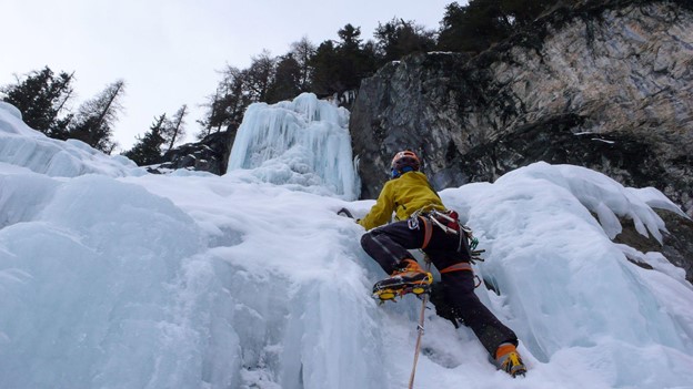 A man climbing an icy mountain