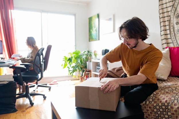 Student in Montreal unboxing his personal belongings.