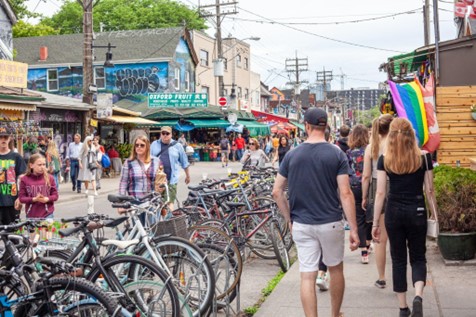 Pedestrians walking along a street in Toronto's Kensington Market