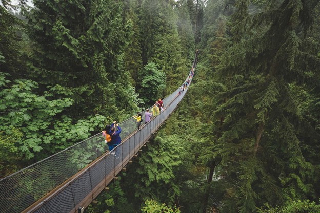 Tourists enjoy a visit to the Capilano Suspension Bridge Park in North Vancouver, B.C. Canada.