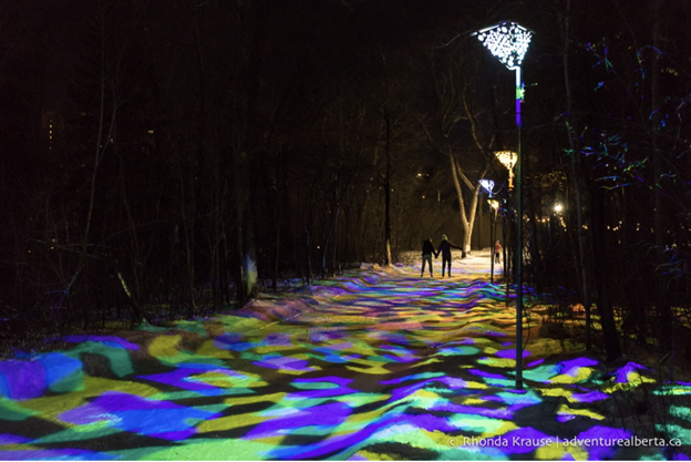 IceWay park lit up with colorful lights and people skating