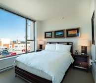 Second bedroom queen bed fully furnished apartment suite 702 Victoria